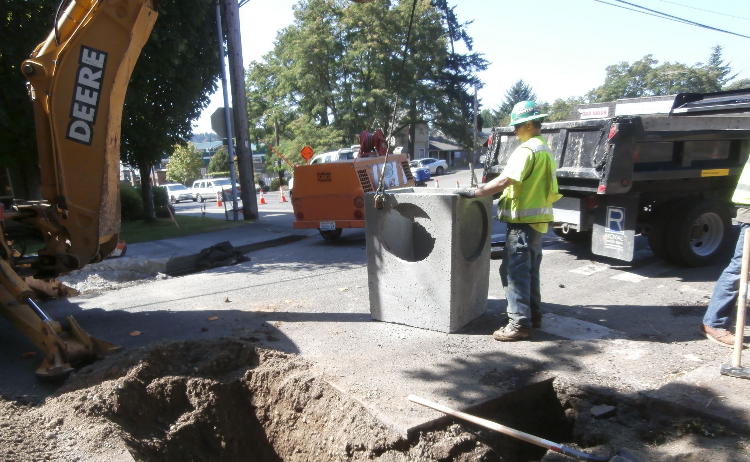 Man with heavy equipment installing infrastructure